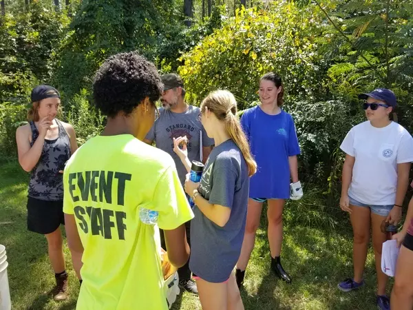 Students holding tiny juvenile turtle