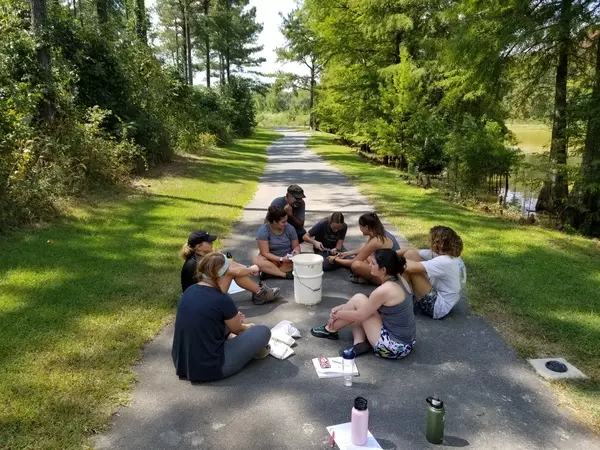 TA guiding students on how to measure turtles